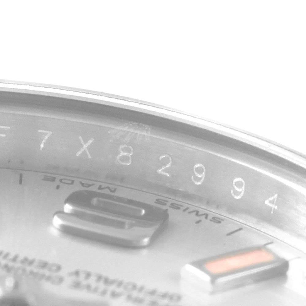 This image shows a close-up of the serial number and a portion of the dial of a Rolex Oyster Perpetual 176200 Women
s Stainless Steel Silver Dial 176200 Women
s Stainless Steel Silver Dial watch.