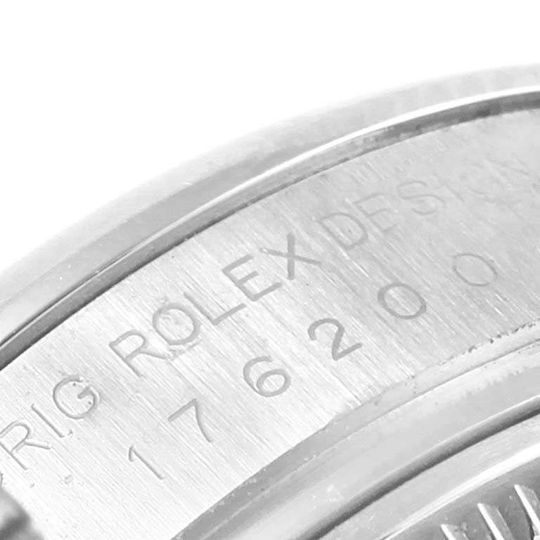 The image shows a close-up of the outer edge of the case back on a Rolex Oyster Perpetual 176200 Women's Stainless Steel Black Dial 176200 Women's Stainless Steel Black Dial watch, displaying engraved text.