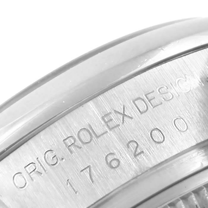 The image shows a close-up of the side of a Rolex Oyster Perpetual 176200 Women
s Stainless Steel Silver Dial 176200 Women
s Stainless Steel Silver Dial watch, featuring the inscription "ORIG. ROLEX DESIGN" and model number "176200."