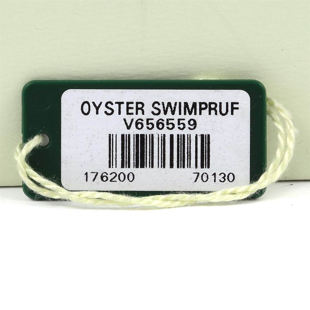 The image shows a Rolex Oyster Perpetual 176200 Women
s Stainless Steel Silver Dial 176200 Women
s Stainless Steel Silver Dial model
s Swimpruf tag with a barcode and reference numbers.