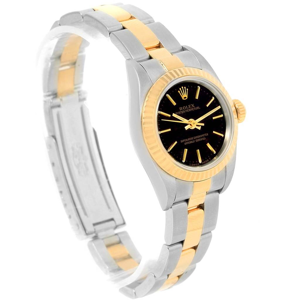 The image shows a side angle view of a Rolex Oyster Perpetual 67193 Women's Steel and Gold (two tone) Black Dial 67193 Women's Steel and Gold (two tone) Black Dial watch, displaying the face, bezel, and two-tone bracelet band.