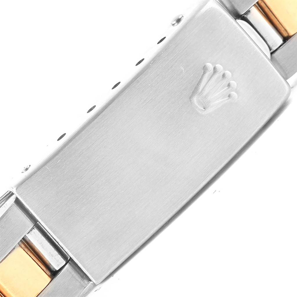 This image shows the clasp of a Rolex Oyster Perpetual 67193 Women's Steel and Gold (two tone) Black Dial 67193 Women's Steel and Gold (two tone) Black Dial watch with a two-tone bracelet.