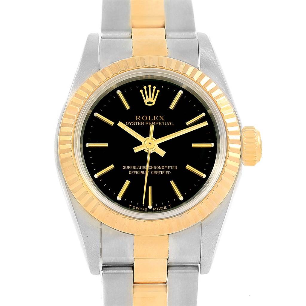 The image shows a front view of the Rolex Oyster Perpetual 67193 Women's Steel and Gold (two tone) Black Dial 67193 Women's Steel and Gold (two tone) Black Dial watch, highlighting its black dial, gold bezel, and bicolor bracelet.