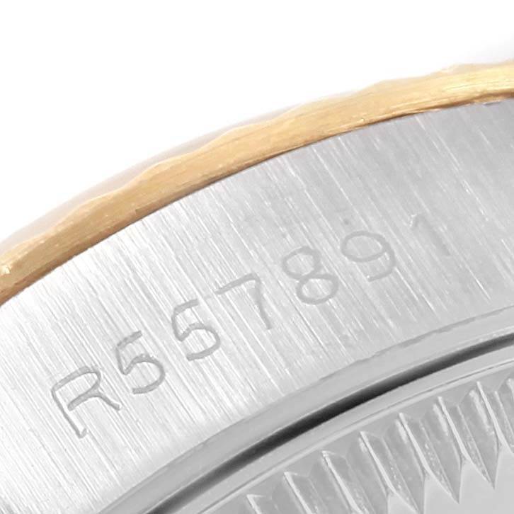 This image shows a close-up of the side of a Rolex Oyster Perpetual 67193 Women
s Steel and Gold (two tone) Silver Dial 67193 Women
s Steel and Gold (two tone) Silver Dial watch, focusing on its engraved serial number.