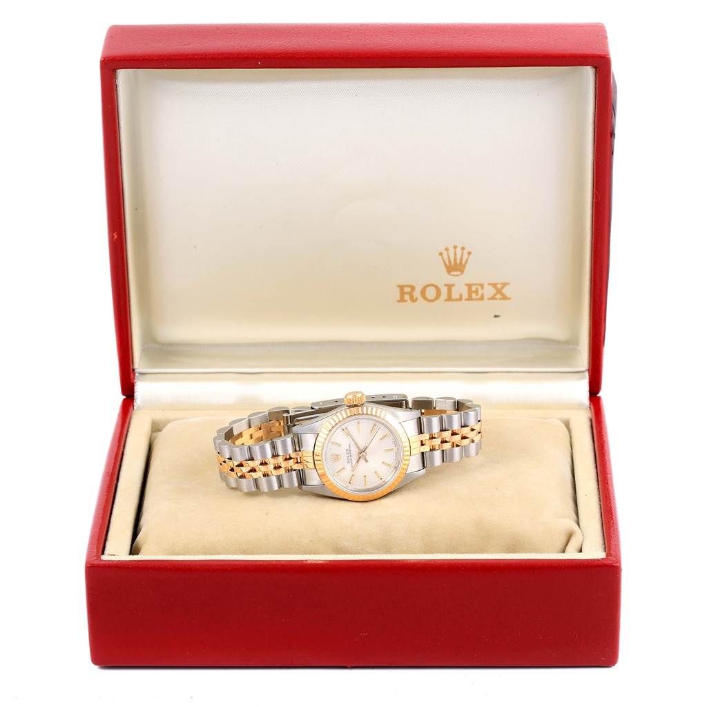 The Rolex Oyster Perpetual 67193 Women
s Steel and Gold (two tone) Silver Dial 67193 Women
s Steel and Gold (two tone) Silver Dial watch is shown from a front angle, displayed in its open box.