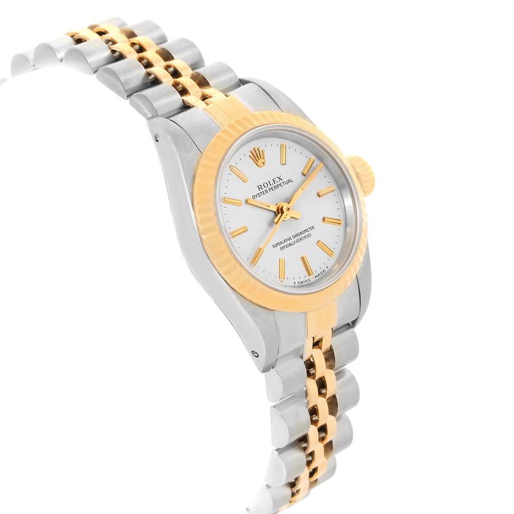 The image shows a side angle of a Rolex Oyster Perpetual 67193 Women
s Steel and Gold (two tone) Silver Dial 67193 Women
s Steel and Gold (two tone) Silver Dial watch, showcasing its two-tone bracelet, bezel, and dial.