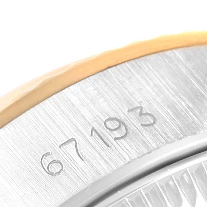 This image shows a close-up of the side of the bezel and case, featuring the serial number of a Rolex Oyster Perpetual 67193 Women
s Steel and Gold (two tone) Silver Dial 67193 Women
s Steel and Gold (two tone) Silver Dial watch.