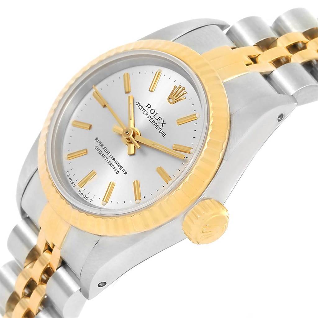 The image shows a Rolex Oyster Perpetual 67193 Women
s Steel and Gold (two tone) Silver Dial 67193 Women
s Steel and Gold (two tone) Silver Dial watch at a tilted angle, highlighting the face, bezel, crown, and bracelet.