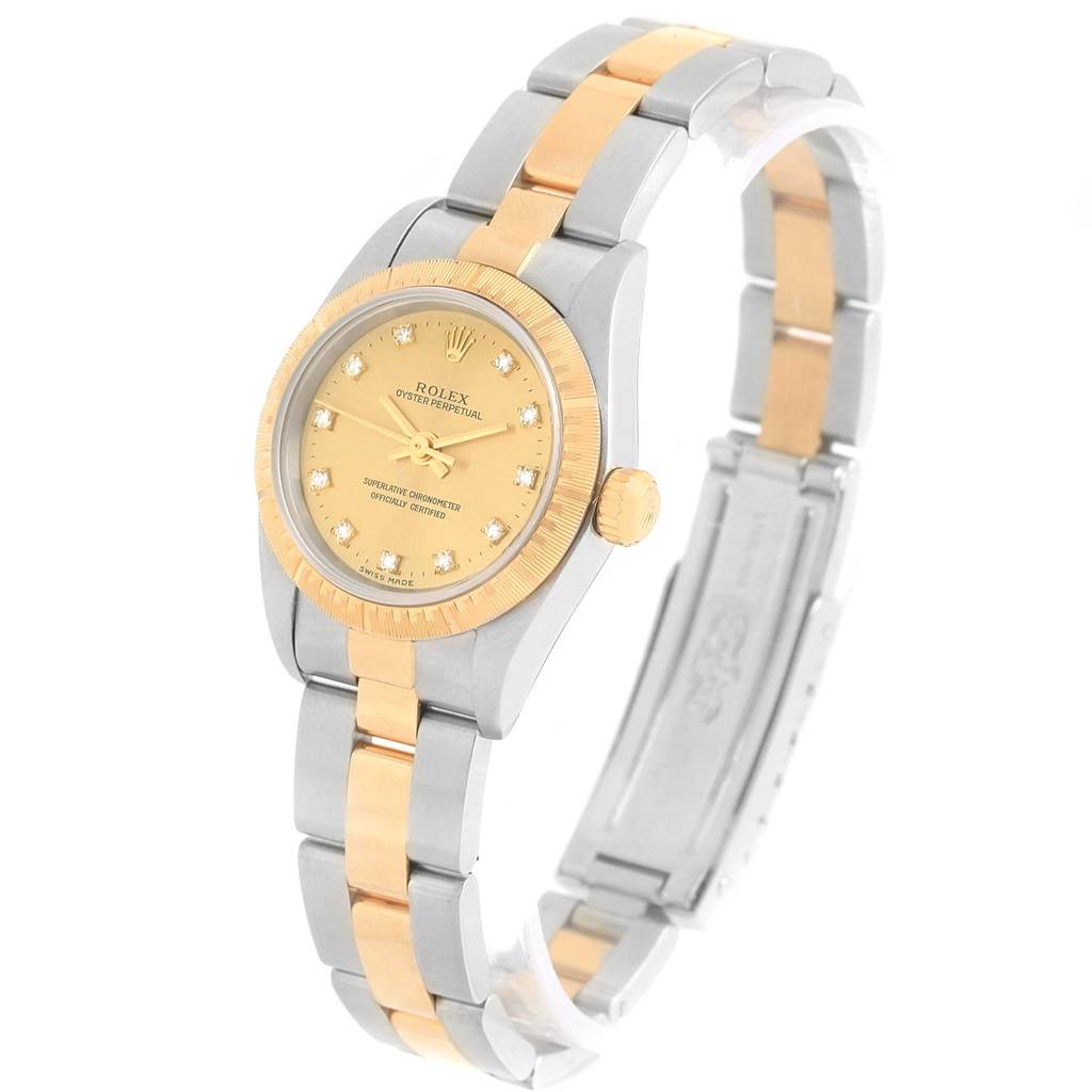 The image shows a side angle view of the Rolex Oyster Perpetual 76243 Women's Steel and Gold (two tone) Champagne Dial 76243 Women's Steel and Gold (two tone) Champagne Dial watch, highlighting its gold and silver bracelet and gold dial.