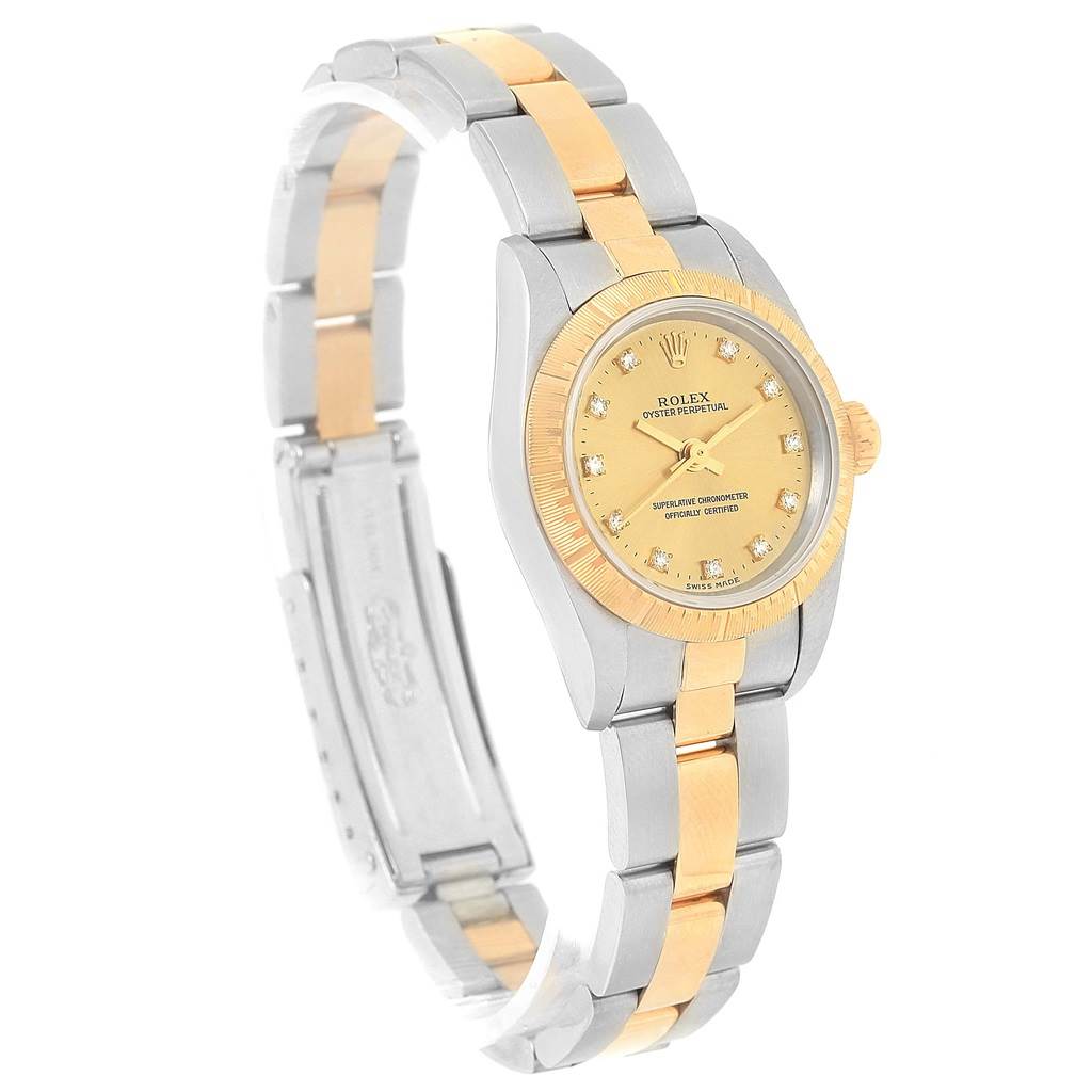 The Rolex Oyster Perpetual 76243 Women's Steel and Gold (two tone) Champagne Dial 76243 Women's Steel and Gold (two tone) Champagne Dial watch is shown at an angle displaying its face, crown, bezel, and two-tone bracelet.