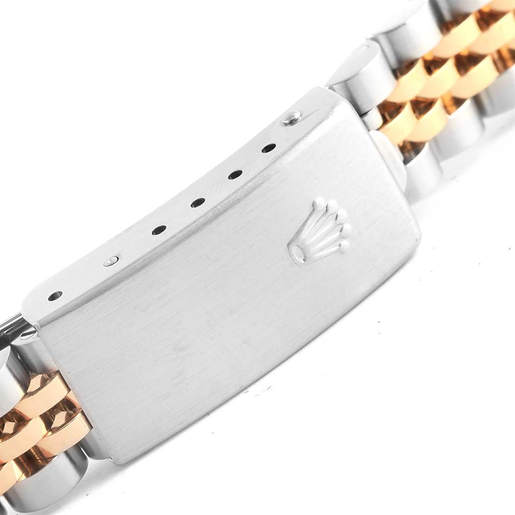 This image shows a close-up of the clasp and part of the bracelet of a Rolex Oyster Perpetual 76183 Women's Steel and Gold (two tone) Black Dial 76183 Women's Steel and Gold (two tone) Black Dial watch.