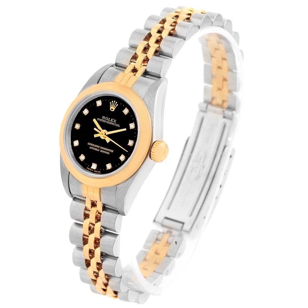 The Rolex Oyster Perpetual 76183 Women's Steel and Gold (two tone) Black Dial 76183 Women's Steel and Gold (two tone) Black Dial watch is shown at a three-quarter angle, highlighting the face, bracelet, and clasp.