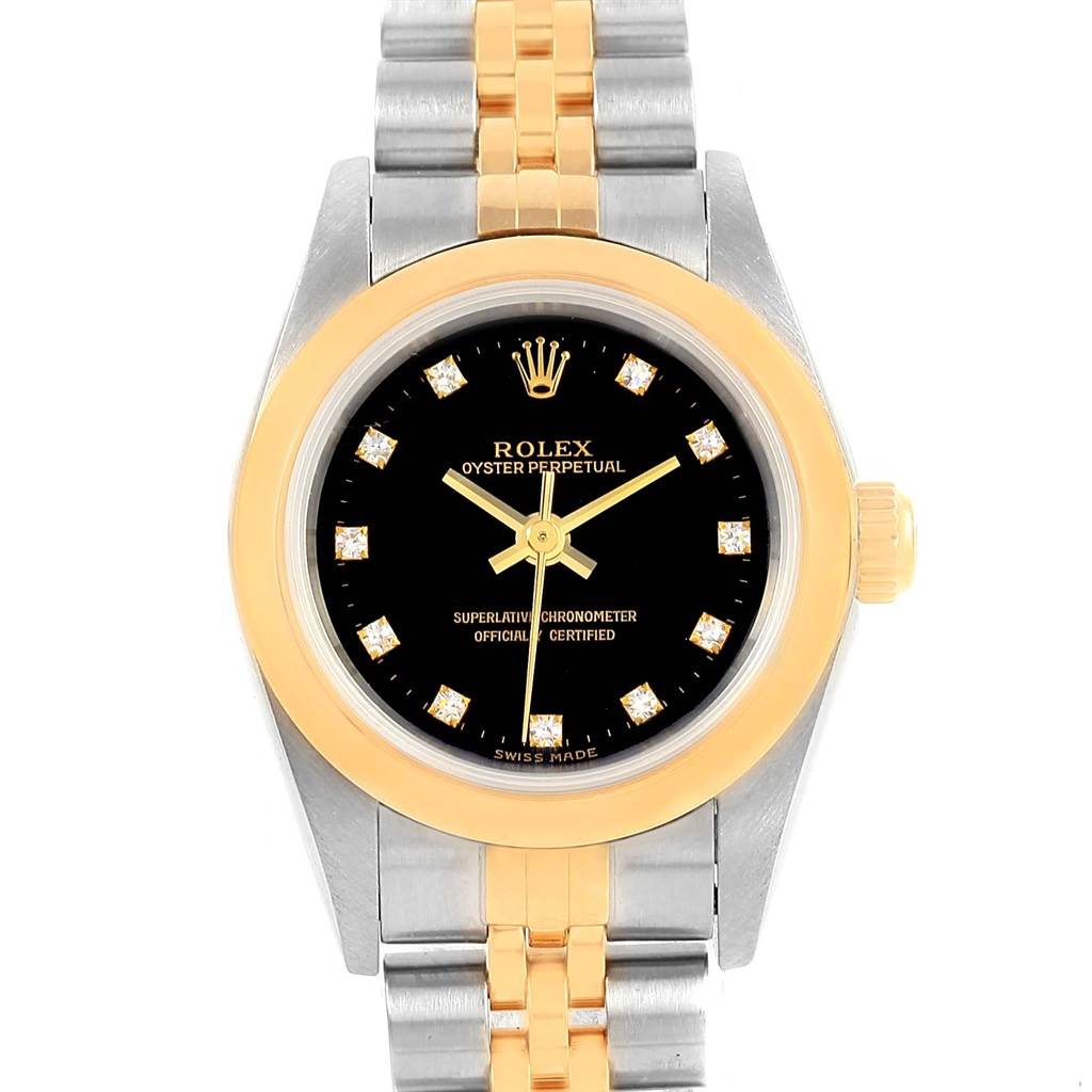 The image shows a front view of a Rolex Oyster Perpetual 76183 Women's Steel and Gold (two tone) Black Dial 76183 Women's Steel and Gold (two tone) Black Dial watch with a gold bezel and a two-tone metal bracelet.