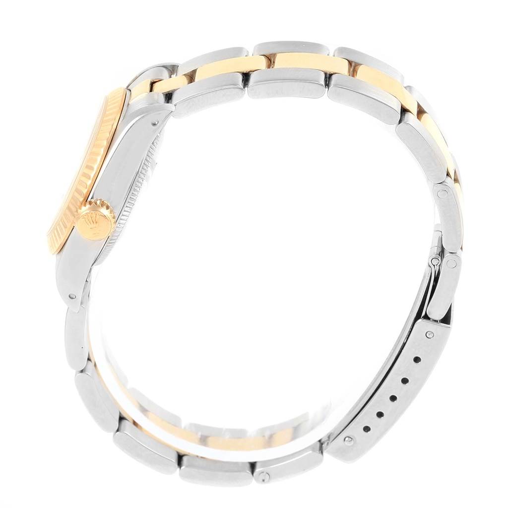 The image shows a side profile of the Rolex Oyster Perpetual 67193 Women
s Steel and Gold (two tone) White Dial 67193 Women
s Steel and Gold (two tone) White Dial watch, focusing on its band and crown.