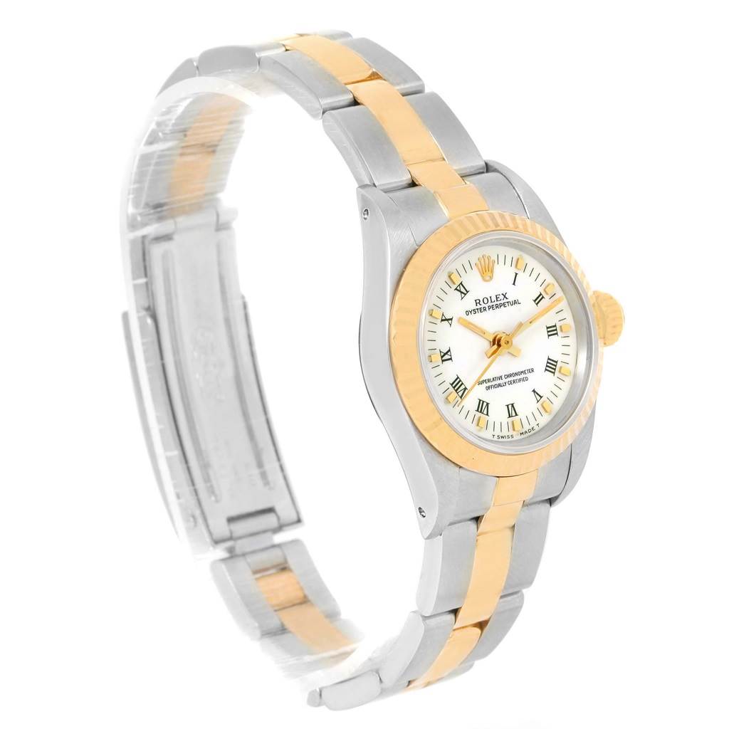 The Rolex Oyster Perpetual 67193 Women
s Steel and Gold (two tone) White Dial 67193 Women
s Steel and Gold (two tone) White Dial watch is shown at a side angle, displaying its two-tone bracelet, bezel, and dial.