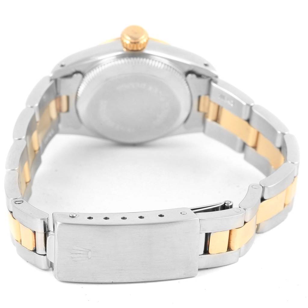 The image shows the back view of a Rolex Oyster Perpetual 67193 Women
s Steel and Gold (two tone) White Dial 67193 Women
s Steel and Gold (two tone) White Dial watch, highlighting its two-tone bracelet and clasp.