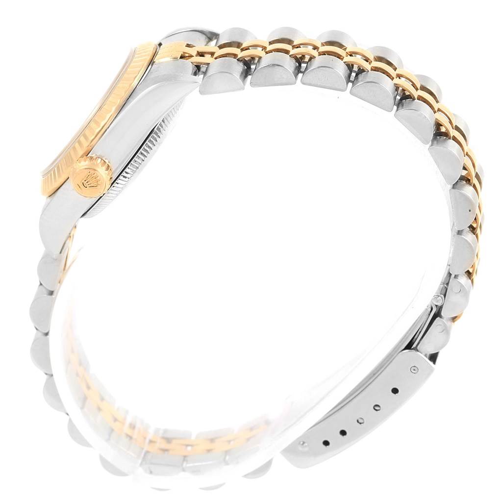 The image shows a side view of a Rolex Oyster Perpetual 67193 Women's Steel and Gold (two tone) Champagne Dial 67193 Women's Steel and Gold (two tone) Champagne Dial watch, highlighting the crown, case, and bracelet.