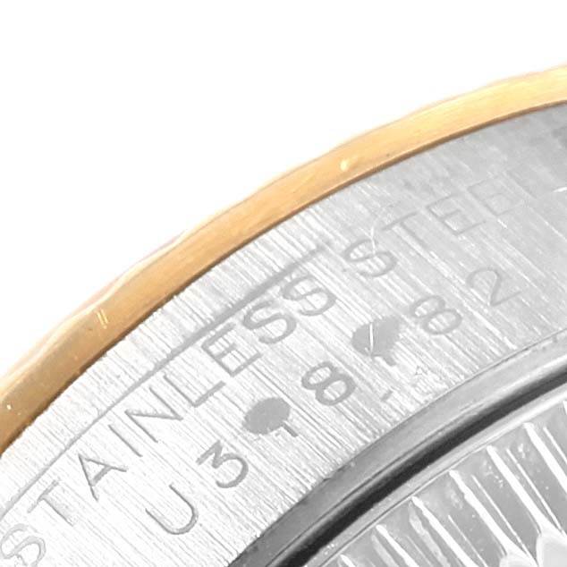 The image shows a close-up angle of the case back edge and bezel of a Rolex Oyster Perpetual 67193 Women's Steel and Gold (two tone) Champagne Dial 67193 Women's Steel and Gold (two tone) Champagne Dial, showcasing the "Stainless Steel" engraving.