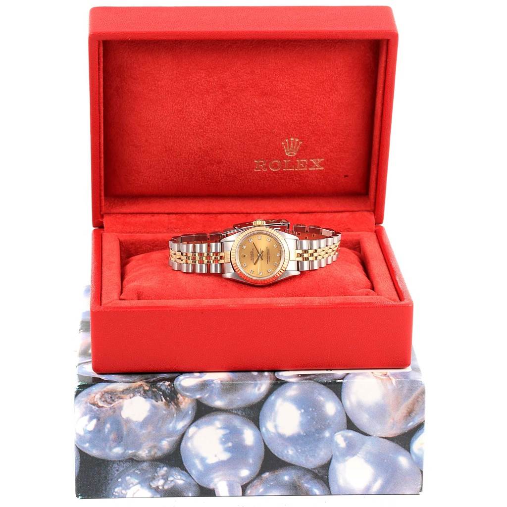 The Rolex Oyster Perpetual 67193 Women's Steel and Gold (two tone) Champagne Dial 67193 Women's Steel and Gold (two tone) Champagne Dial watch is displayed front-facing in an open red box, showing the dial and bracelet.