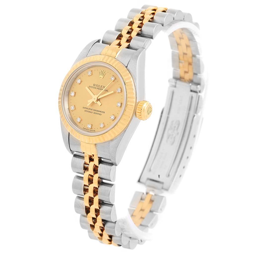 The image shows a Rolex Oyster Perpetual 67193 Women's Steel and Gold (two tone) Champagne Dial 67193 Women's Steel and Gold (two tone) Champagne Dial watch from an angled side view, highlighting its face, bezel, and two-tone bracelet.