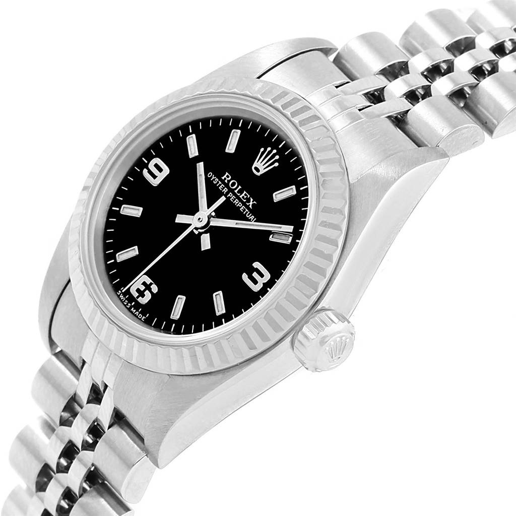 The image shows a side view of the Rolex Oyster Perpetual 76094 Women's Stainless Steel Black Dial 76094 Women's Stainless Steel Black Dial watch, highlighting its black dial, bezel, crown, and bracelet.