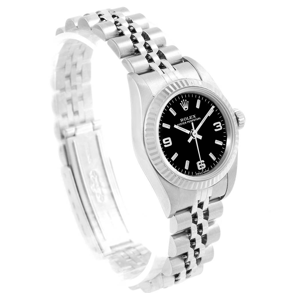 This image shows a Rolex Oyster Perpetual 76094 Women's Stainless Steel Black Dial 76094 Women's Stainless Steel Black Dial watch at an angled view highlighting the black dial, fluted bezel, and jubilee bracelet.