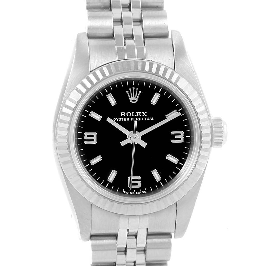 This image shows a front view of a Rolex Oyster Perpetual 76094 Women's Stainless Steel Black Dial 76094 Women's Stainless Steel Black Dial watch, displaying its black dial, fluted bezel, and metal bracelet.
