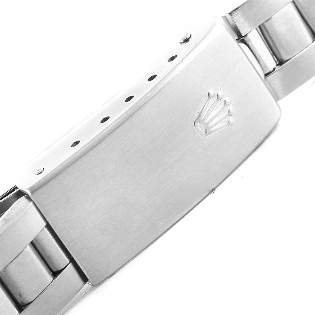 This image shows a close-up of the clasp and part of the bracelet of a Rolex Oyster Perpetual 76080 Women
s Stainless Steel Pink Dial 76080 Women
s Stainless Steel Pink Dial watch.