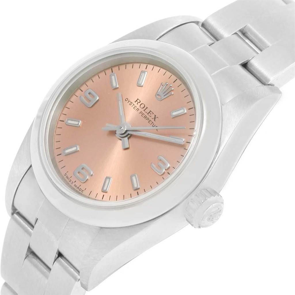 The image shows a close-up angled view of the Rolex Oyster Perpetual 76080 Women
s Stainless Steel Pink Dial 76080 Women
s Stainless Steel Pink Dial watch, highlighting its face, bezel, and bracelet.