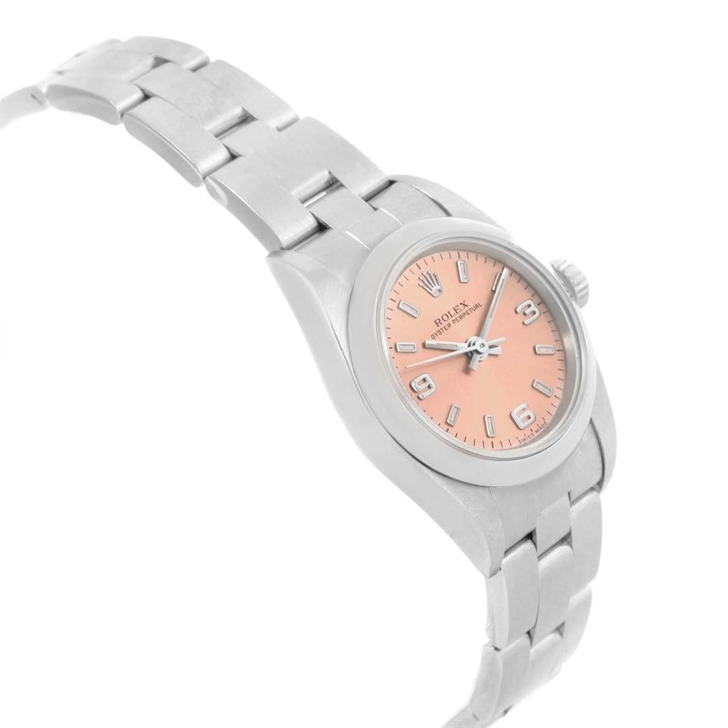 The image shows a side-angle view of a Rolex Oyster Perpetual 76080 Women
s Stainless Steel Pink Dial 76080 Women
s Stainless Steel Pink Dial watch, highlighting the band, case, and dial with pink face.
