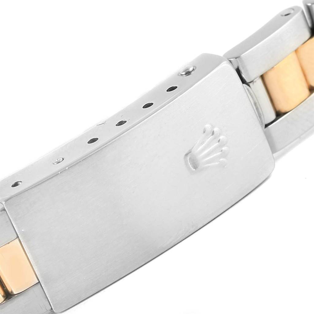 This image shows a close-up of the clasp and part of the bracelet of a Rolex Oyster Perpetual 76183 Women
s Steel and Gold (two tone) Champagne Dial 76183 Women
s Steel and Gold (two tone) Champagne Dial watch.