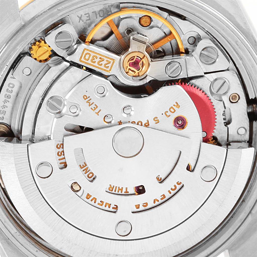 This image shows the intricate internal mechanism and rotor of a Rolex Oyster Perpetual 76183 Women
s Steel and Gold (two tone) Champagne Dial 76183 Women
s Steel and Gold (two tone) Champagne Dial watch from a detailed, close-up angle.