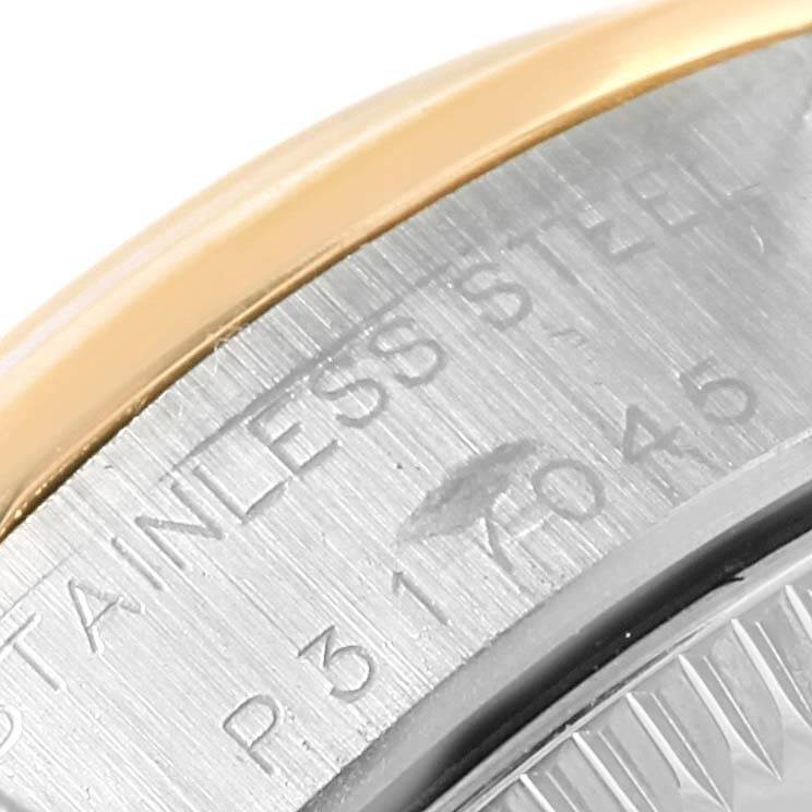 This image shows a close-up of the stainless steel back and edge of the bezel of a Rolex Oyster Perpetual 76183 Women
s Steel and Gold (two tone) Champagne Dial 76183 Women
s Steel and Gold (two tone) Champagne Dial watch.
