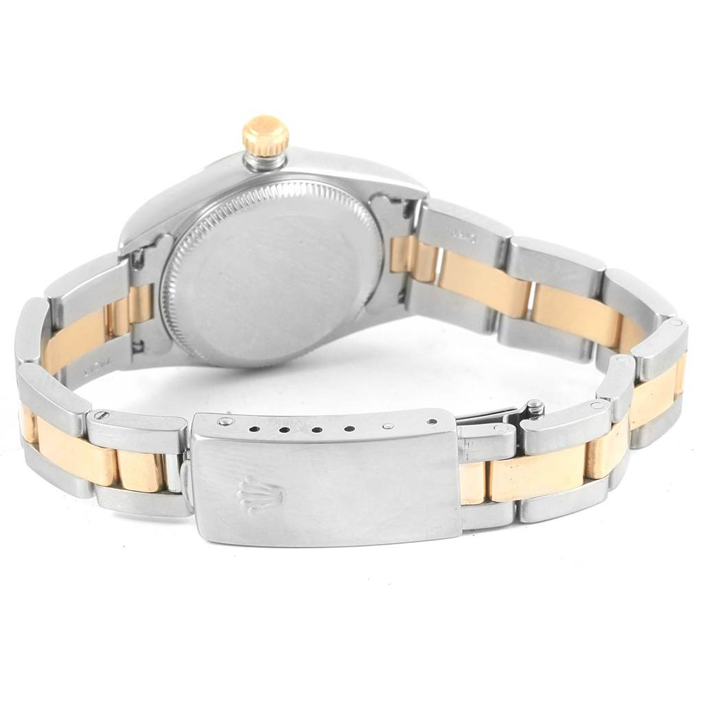 This image shows the back view of a Rolex Oyster Perpetual 76183 Women
s Steel and Gold (two tone) Champagne Dial 76183 Women
s Steel and Gold (two tone) Champagne Dial watch, highlighting the case back, crown, and two-tone bracelet with clasp.