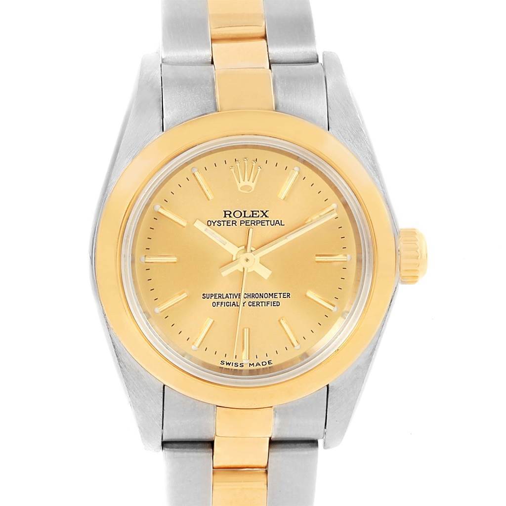 The image shows a frontal view of a Rolex Oyster Perpetual 76183 Women
s Steel and Gold (two tone) Champagne Dial 76183 Women
s Steel and Gold (two tone) Champagne Dial watch, highlighting the dial, bezel, and part of the bracelet.