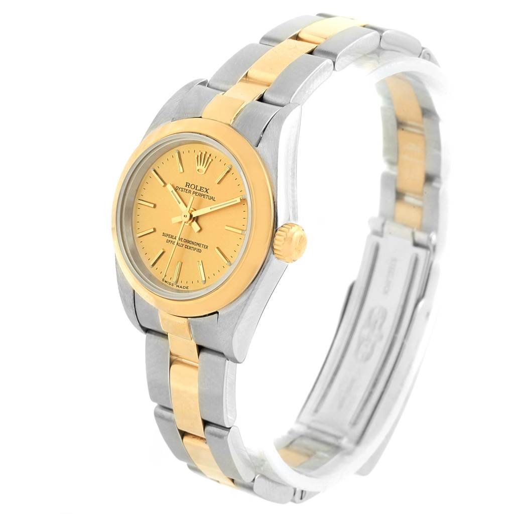 This image shows a Rolex Oyster Perpetual 76183 Women
s Steel and Gold (two tone) Champagne Dial 76183 Women
s Steel and Gold (two tone) Champagne Dial watch with a gold dial and two-tone metal bracelet from a 3/4 angle view.