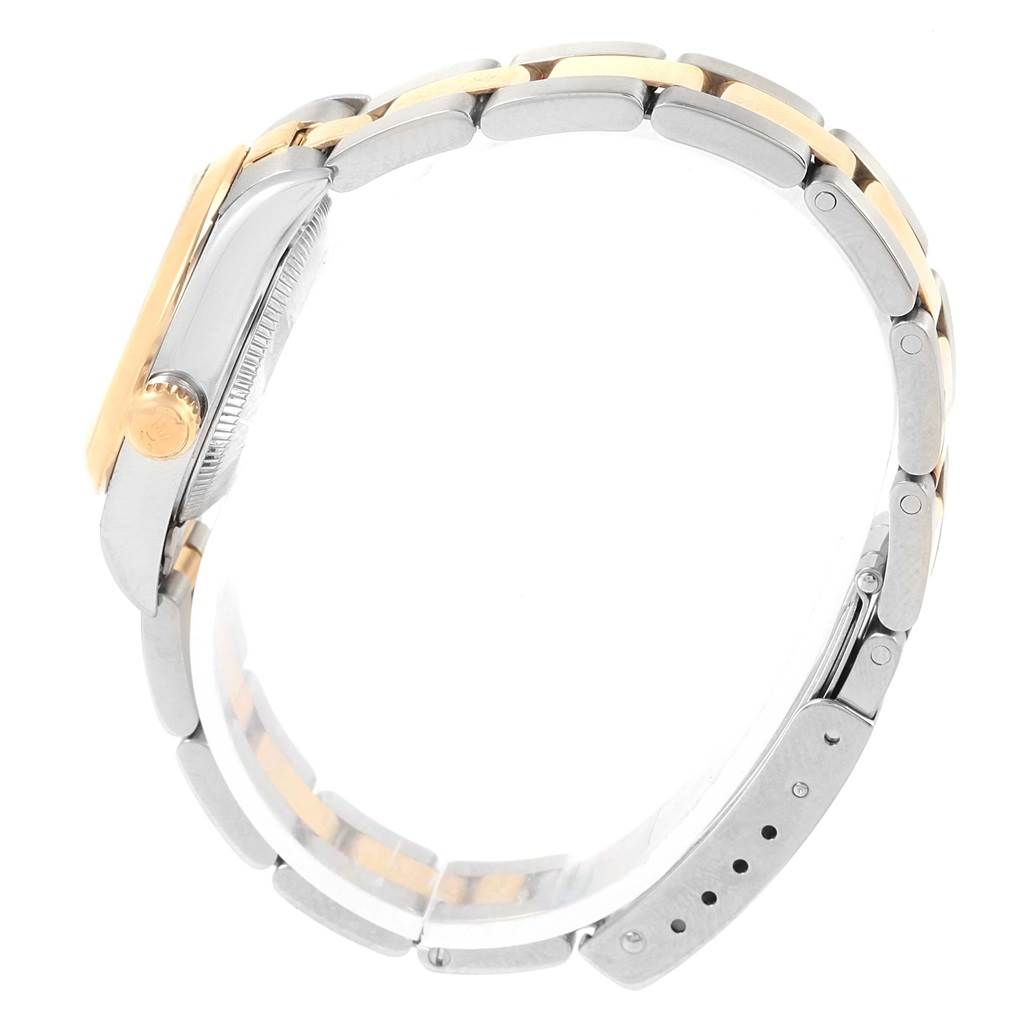 This image shows the side view of a Rolex Oyster Perpetual 76183 Women
s Steel and Gold (two tone) Champagne Dial 76183 Women
s Steel and Gold (two tone) Champagne Dial watch, highlighting its case, crown, and two-tone bracelet.