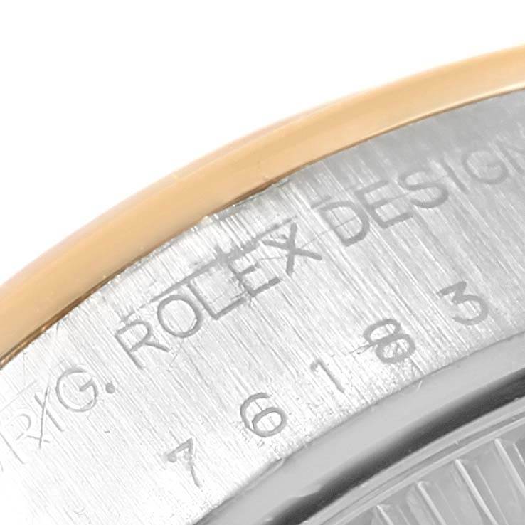 This close-up image shows the side engraving and part of the bezel of a Rolex Oyster Perpetual 76183 Women
s Steel and Gold (two tone) Champagne Dial 76183 Women
s Steel and Gold (two tone) Champagne Dial watch.