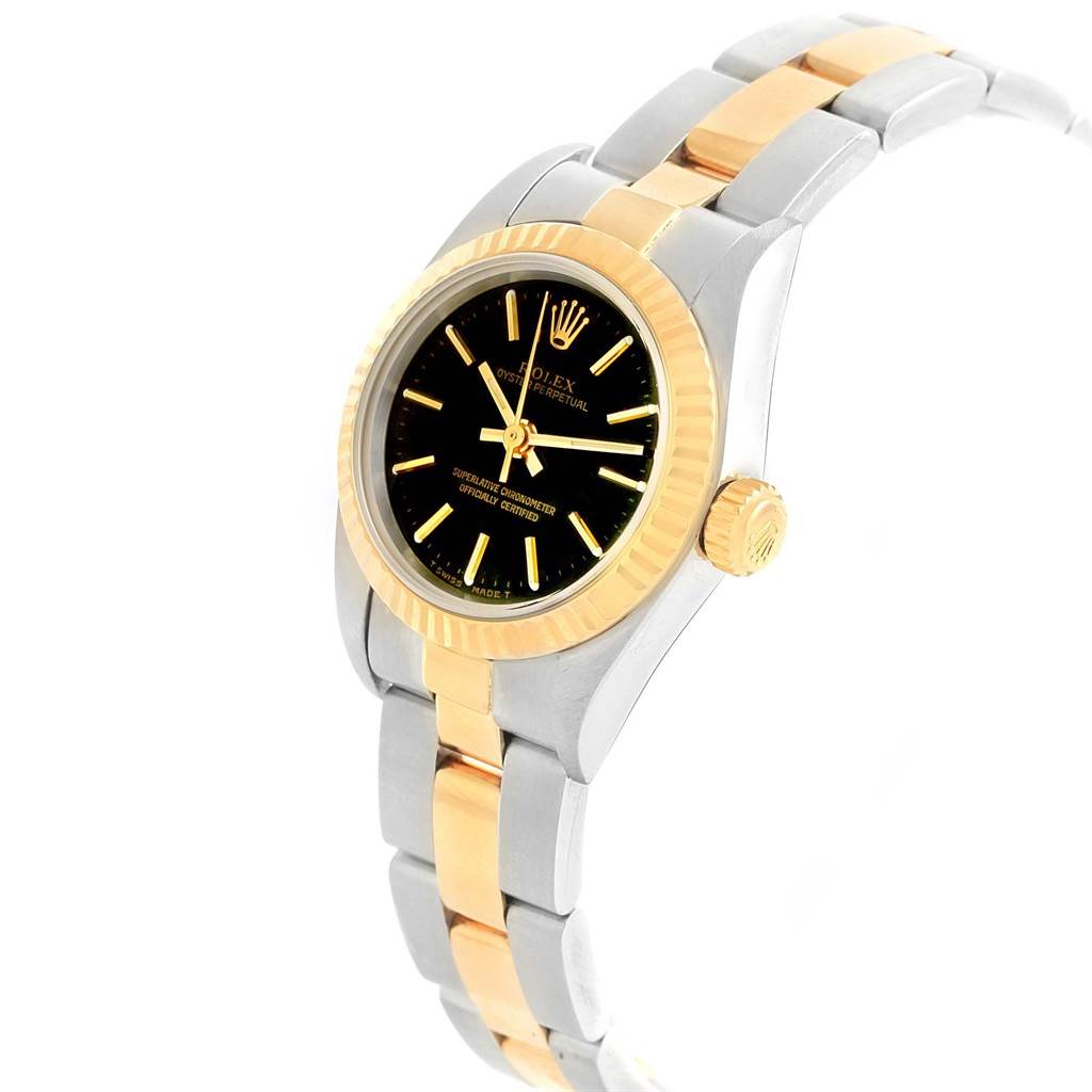 This image shows a side and partial front view of a Rolex Oyster Perpetual 67193 Women's Steel and Gold (two tone) Black Dial 67193 Women's Steel and Gold (two tone) Black Dial watch with a two-tone bracelet and fluted bezel.