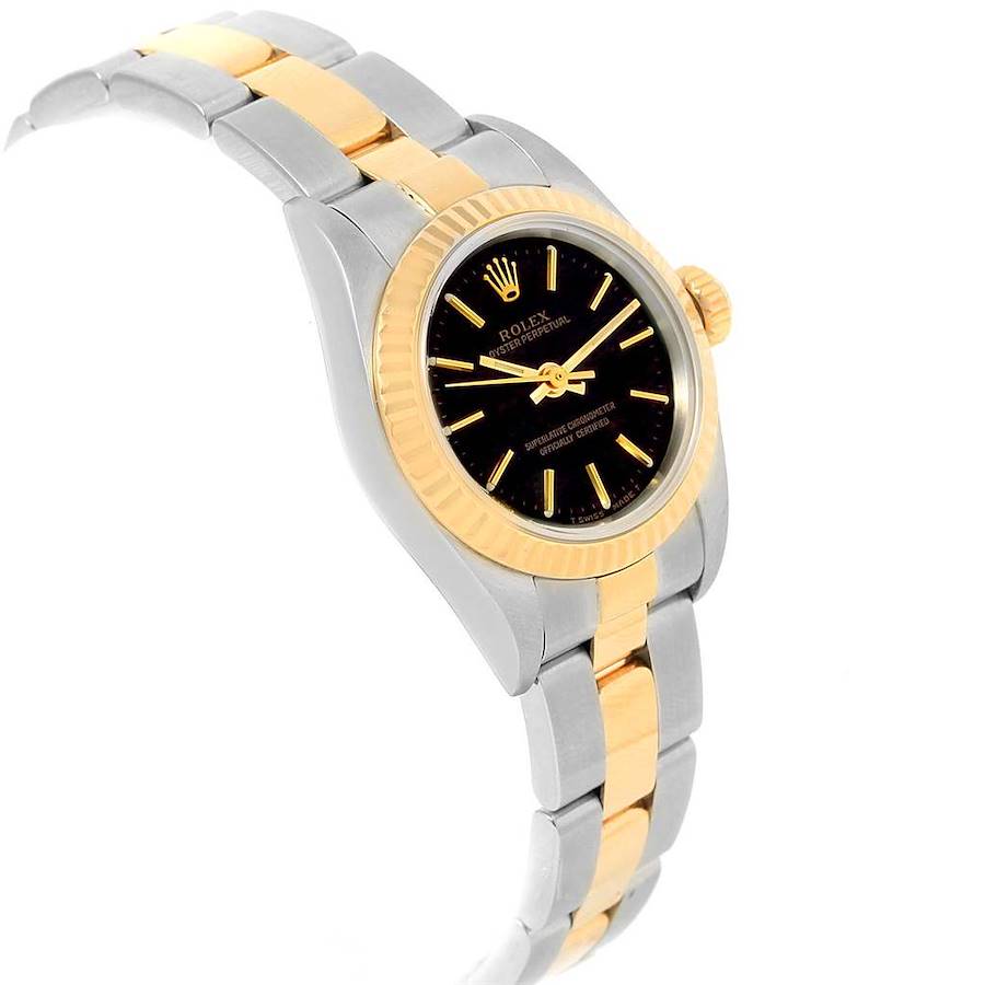 The Rolex Oyster Perpetual watch is shown from a slight side angle, displaying the face, crown, and two-tone metal bracelet.