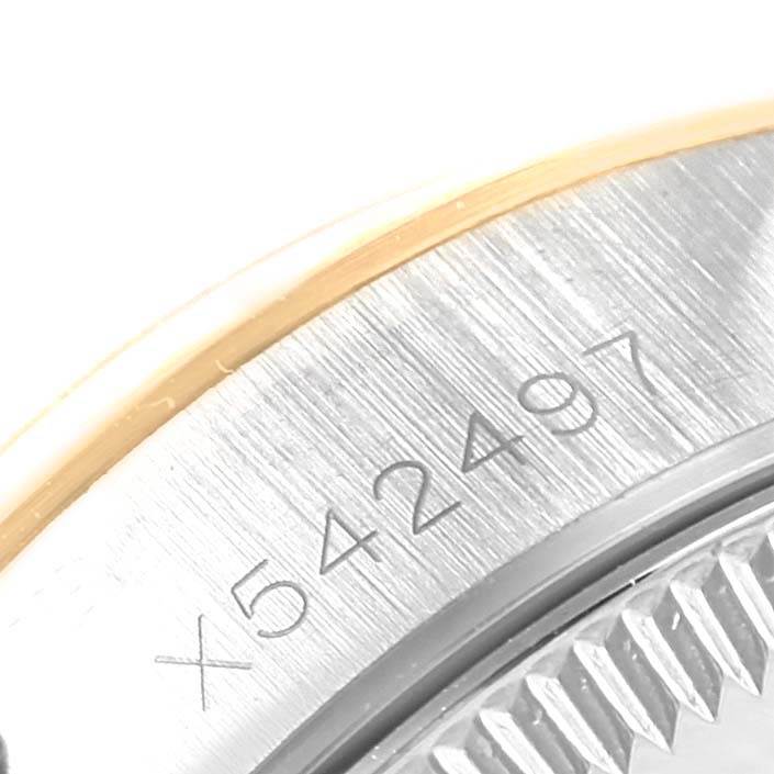 The image shows a macro view of the serial number on the side of the case of a Rolex Oyster Perpetual 67193 Women's Steel and Gold (two tone) Champagne Dial 67193 Women's Steel and Gold (two tone) Champagne Dial watch.