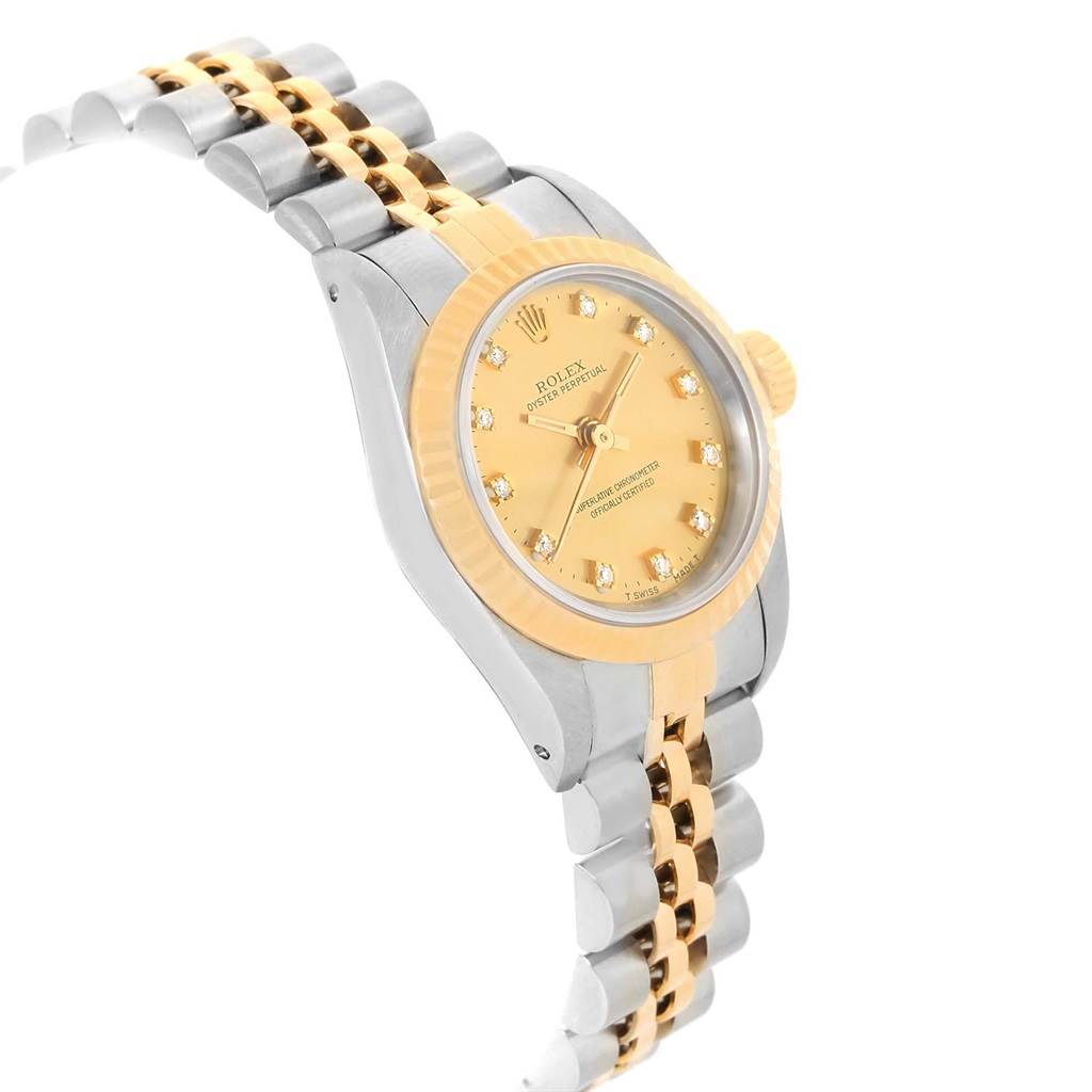 This Rolex Oyster Perpetual 67193 Women's Steel and Gold (two tone) Champagne Dial 67193 Women's Steel and Gold (two tone) Champagne Dial model is shown from an angled side view, displaying the watch face, bezel, crown, and part of the bracelet.