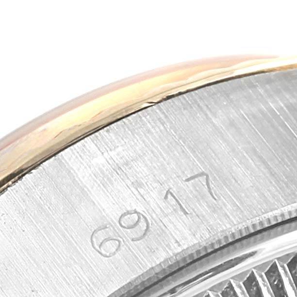 The image shows a close-up of the rim and case back of a Rolex Oyster Perpetual 6917 Women's Stainless Steel Champagne Dial 6917 Women's Stainless Steel Champagne Dial watch, with the model number 6917 engraved.