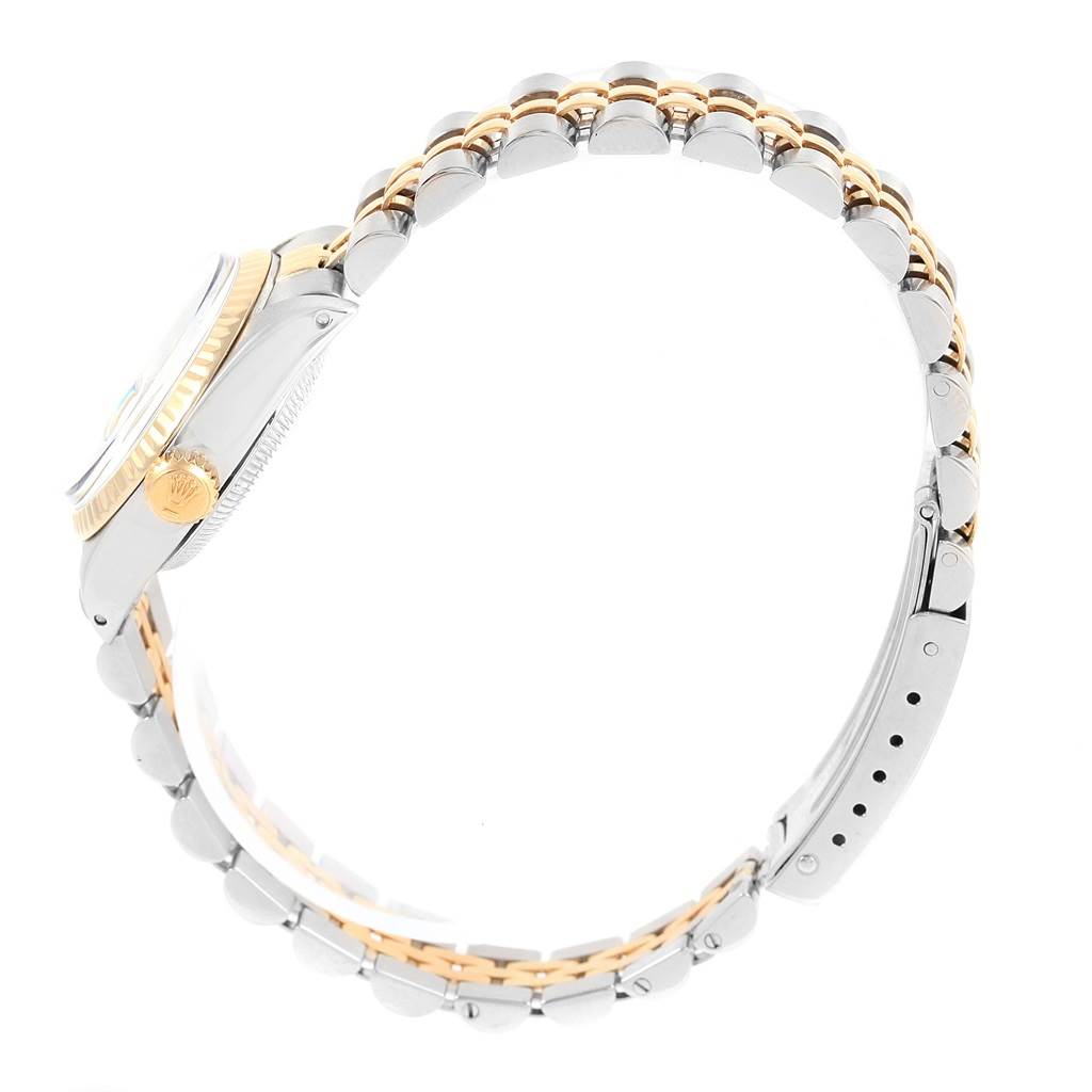 This side-angle view shows the band and crown of the Rolex Oyster Perpetual 6917 Women's Stainless Steel Champagne Dial 6917 Women's Stainless Steel Champagne Dial watch.