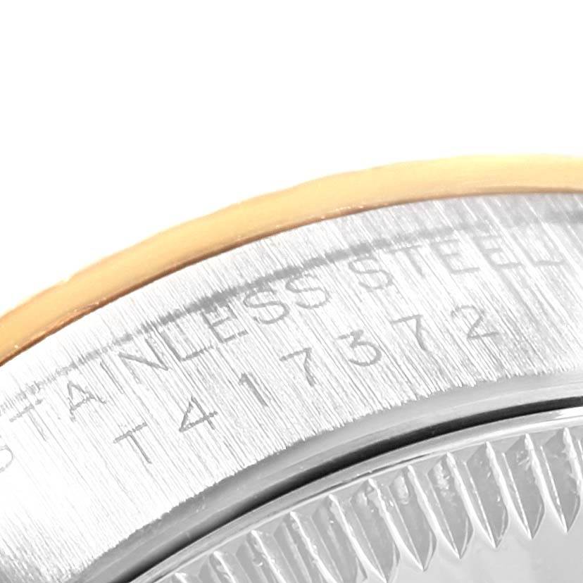 This close-up image shows part of the stainless steel case and bezel of a Rolex Oyster Perpetual 67193 Women's Steel and Gold (two tone) Black Dial 67193 Women's Steel and Gold (two tone) Black Dial watch.