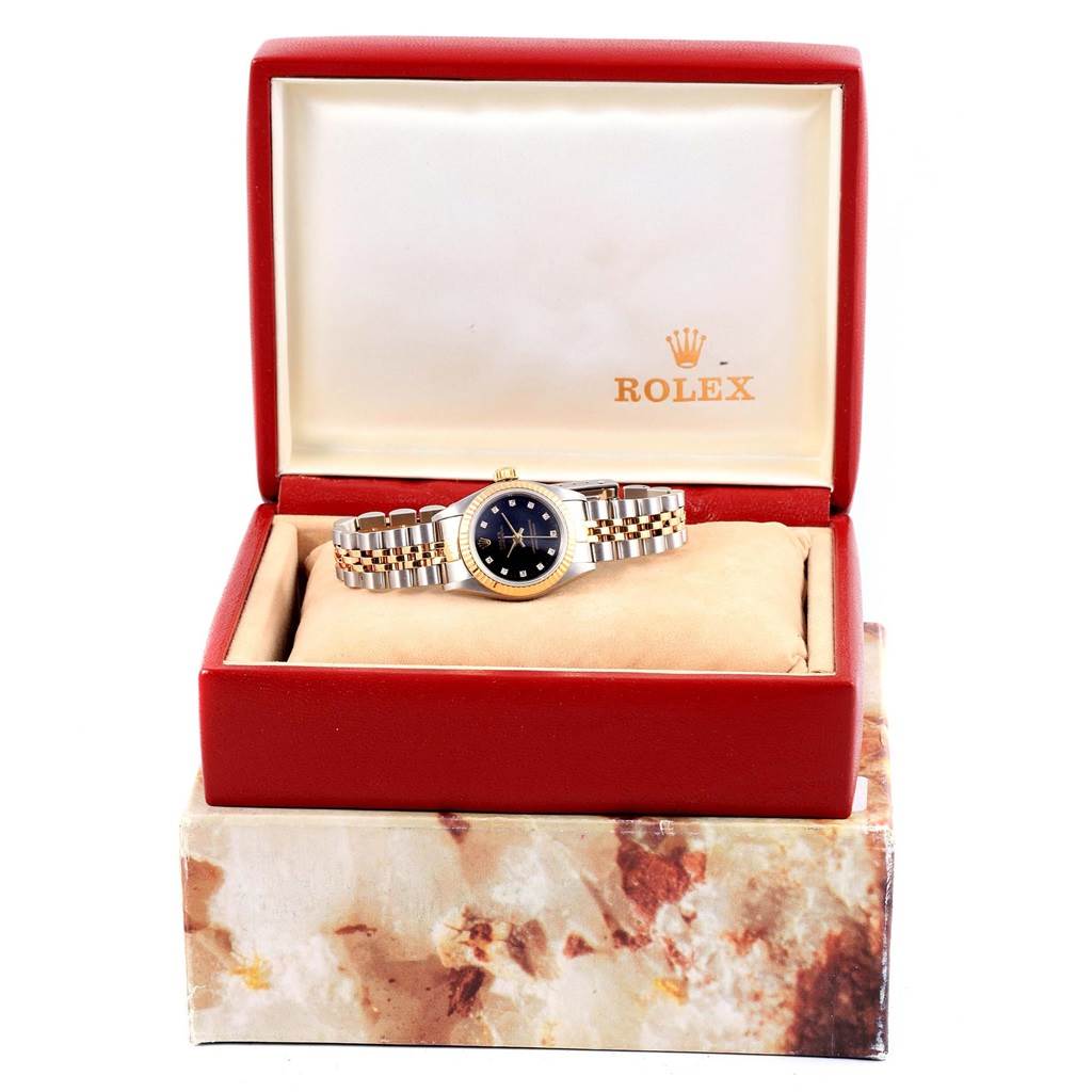 The Rolex Oyster Perpetual 67193 Women's Steel and Gold (two tone) Black Dial 67193 Women's Steel and Gold (two tone) Black Dial watch is displayed head-on, housed in its opened case.