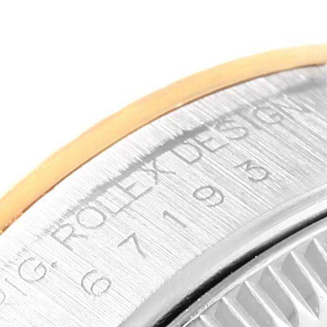 The image shows a close-up of the side of a Rolex Oyster Perpetual 67193 Women's Steel and Gold (two tone) Black Dial 67193 Women's Steel and Gold (two tone) Black Dial watch, highlighting the engraved model number and "Rolex Design."