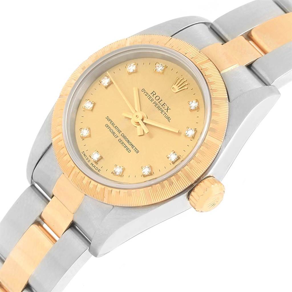 The Rolex Oyster Perpetual 76243 Women's Steel and Gold (two tone) Champagne Dial 76243 Women's Steel and Gold (two tone) Champagne Dial watch is shown from an angled top view, highlighting the dial, crown, and two-tone band.
