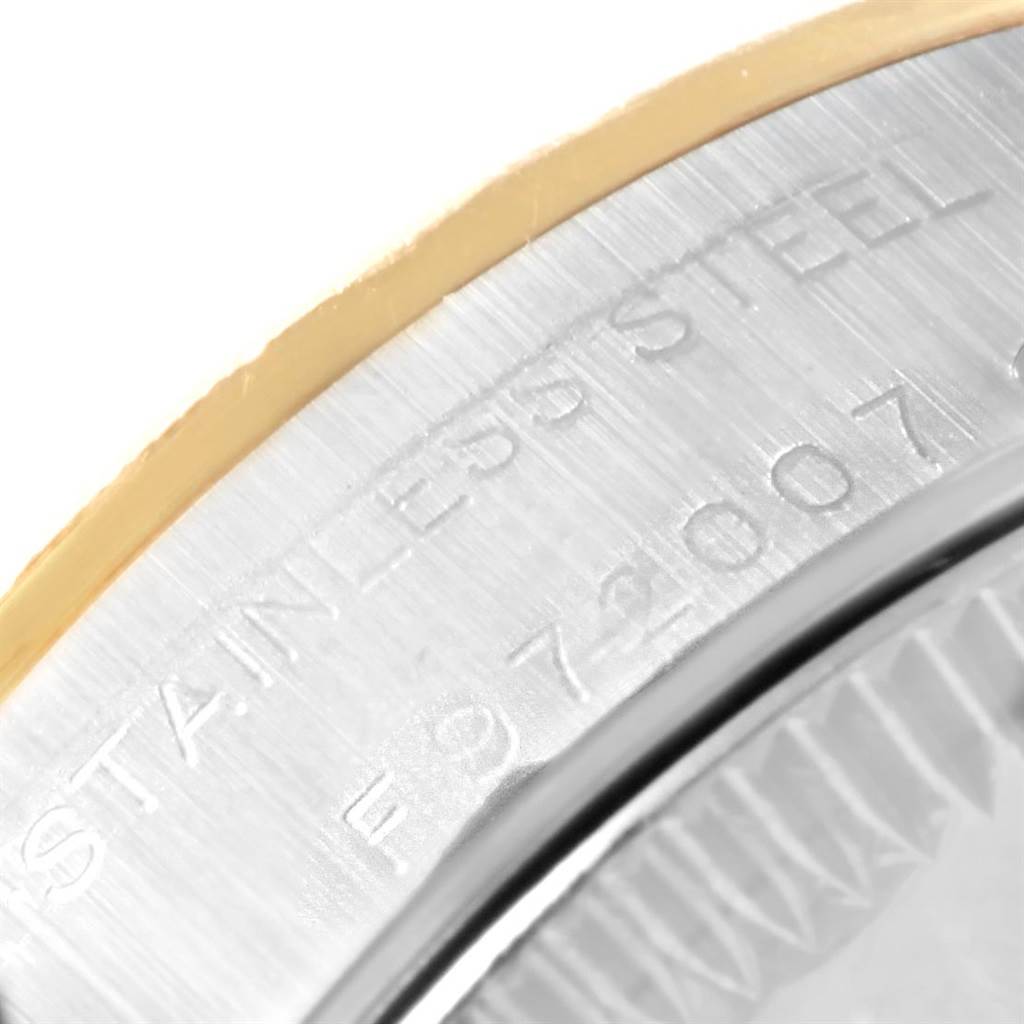 This close-up image shows the edge of the case back with the engraved text of a Rolex Oyster Perpetual 76243 Women's Steel and Gold (two tone) Champagne Dial 76243 Women's Steel and Gold (two tone) Champagne Dial watch.