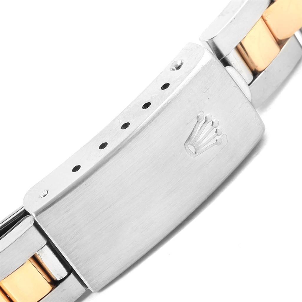This image shows a close-up of the clasp on a Rolex Oyster Perpetual 76183 Women's Steel and Gold (two tone) Silver Dial 76183 Women's Steel and Gold (two tone) Silver Dial watch bracelet.